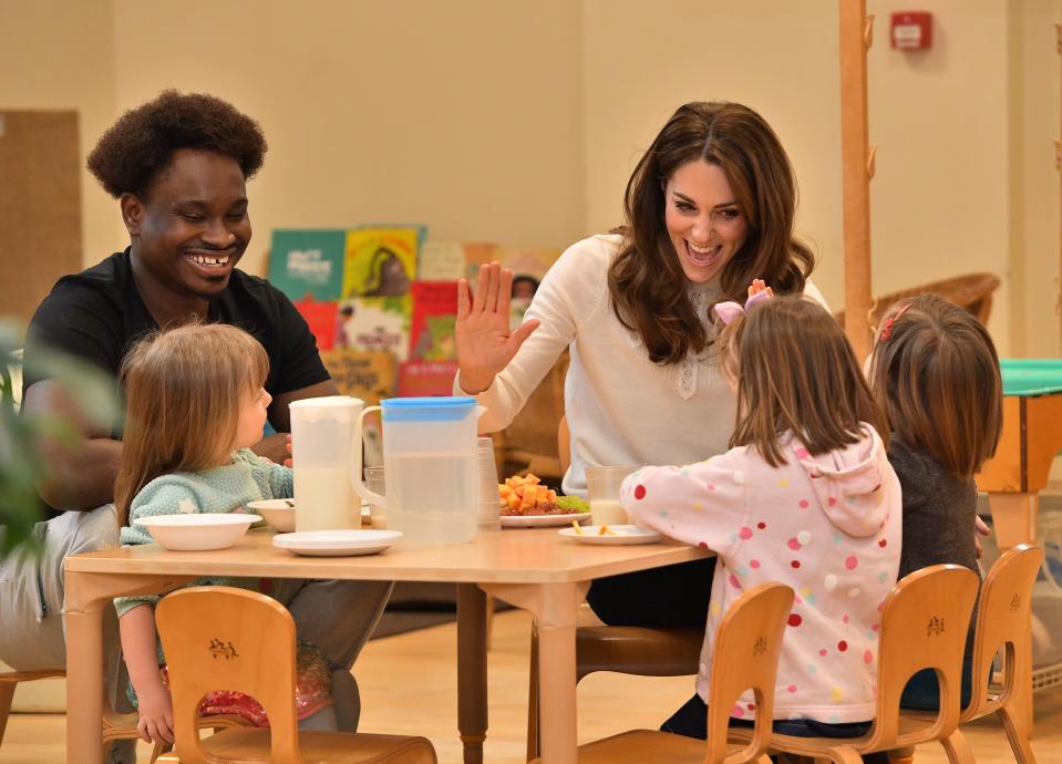 Duchess of Cambridge high-fives children during a breakfast visit to London Early Years Foundation (LEYF) at Stockwell Gardens Nursery and Pre-school. [Photo: Getty]