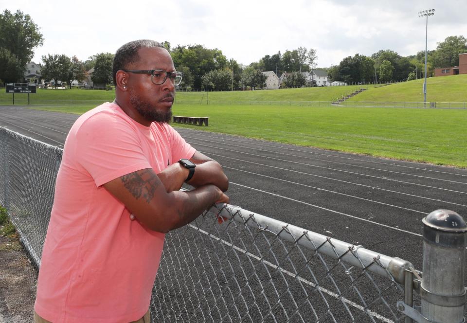 William McWain, a social worker with Minority Behavioral Health at Helen Arnold CLC and a peewee football coach, looks over the field at Lane Field Park in Akron. McWain was at the field when Tyren Thompson, 7, was shot after a youth football game.