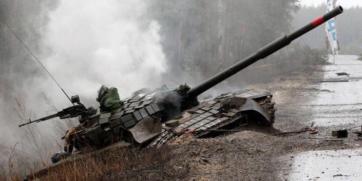 A Russian tank destroyed by Ukrainian fighters lies at the side of the road in the Lugansk region of Ukraine.