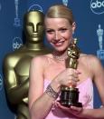 Gwyneth Paltrow poses backstage with her best actress Oscar for her role in "Shakespeare in Love," at the 71st Annual Academy Awards at the Dorothy Chandler Pavilion of the Los Angeles Music Center Sunday, March 21, 1999. (AP Photo/Reed Saxon)