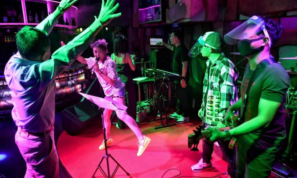 A band plays for a customer in a near-empty bar in the Patpong area of the city.