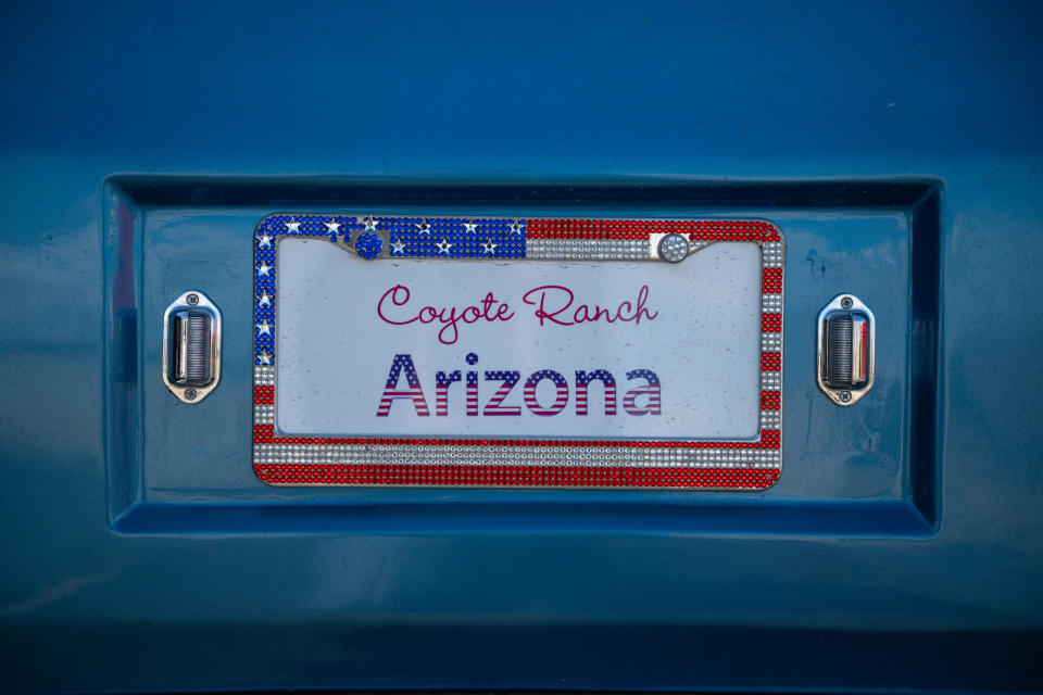 A decorative license plate adorns a resident’s golf cart at Coyote Ranch. (Caitlin O'Hara for The Washington Post)