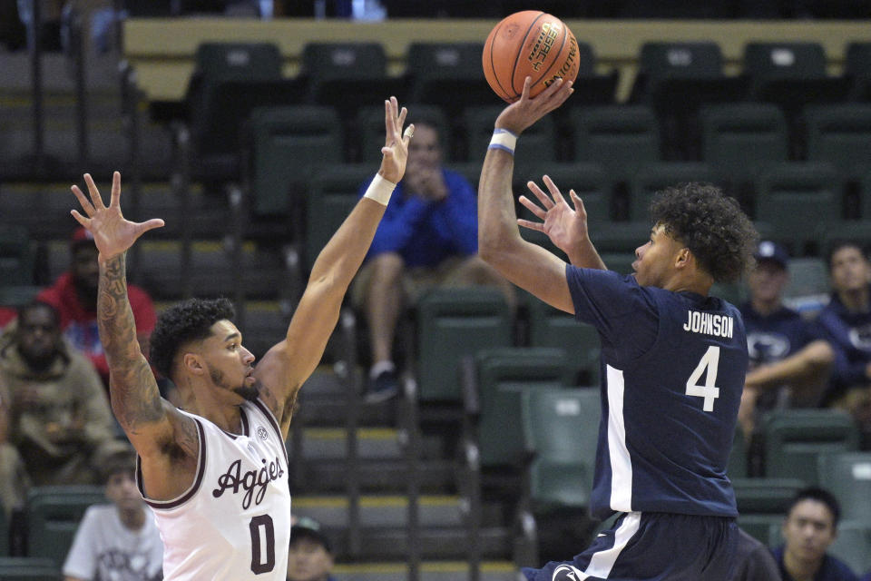 Penn State forward Puff Johnson (4) shoots in front of Texas A&M guard Jace Carter (0) during the second half of an NCAA college basketball game, Thursday, Nov. 23, 2023, in Kissimmee, Fla. (AP Photo/Phelan M. Ebenhack)