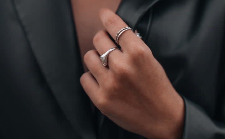 Closeup of a woman's hand wearing rings