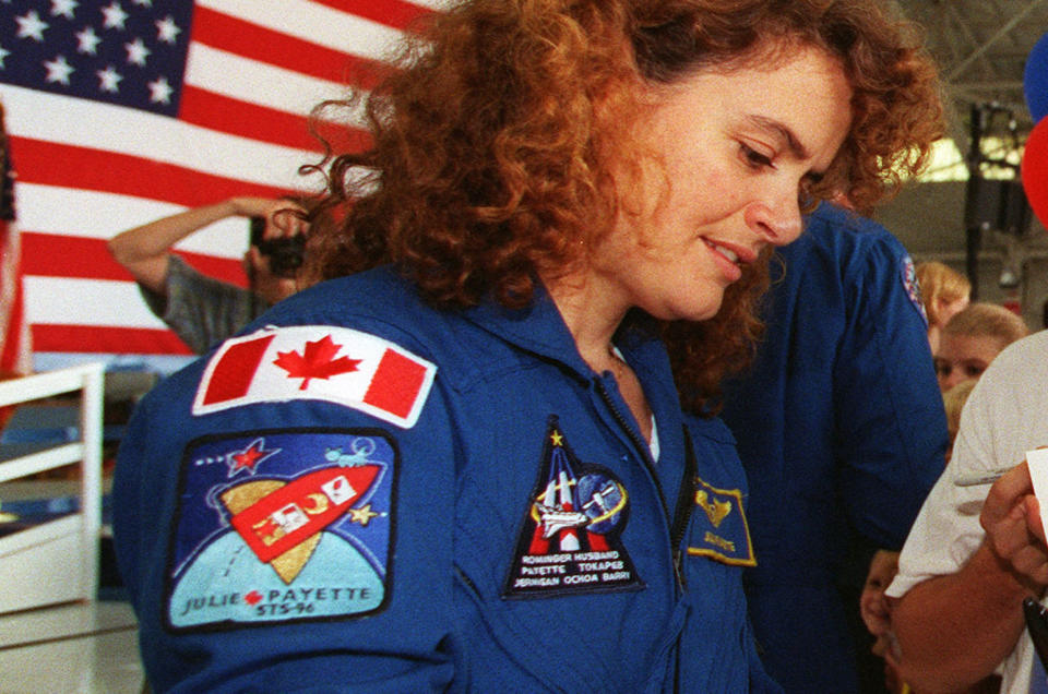 Canadian Space Agency astronaut Julie Payette, seen in 1999 after her first spaceflight, wearing her personal mission patch. <cite>NASA</cite>