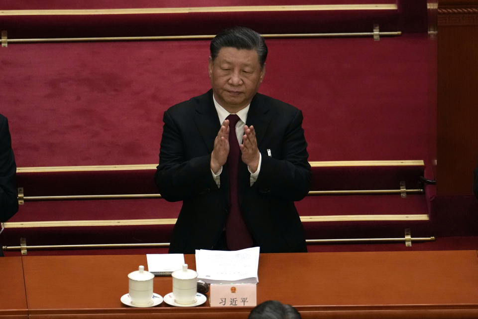 Chinese President Xi Jinping applauds during the opening session of China's National People's Congress (NPC) at the Great Hall of the People in Beijing, Sunday, March 5, 2023. (AP Photo/Ng Han Guan)