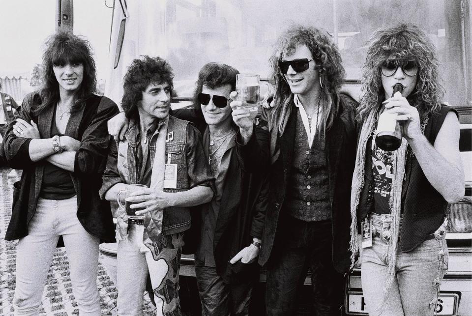 <p>The band members of Bon Jovi (which includes Richie Sambora, Alec John Such, Tico Torres, David Bryan, and Jon Bon Jovi) toast their performance at the Monsters of Rock festival in 1986. </p>