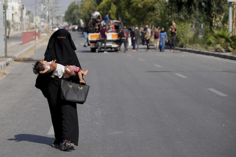 Palestinians flee the southern Gaza Strip on Salah al-Din street in Bureij on Sunday, Nov. 5, 2023. (AP Photo/Hatem Moussa)