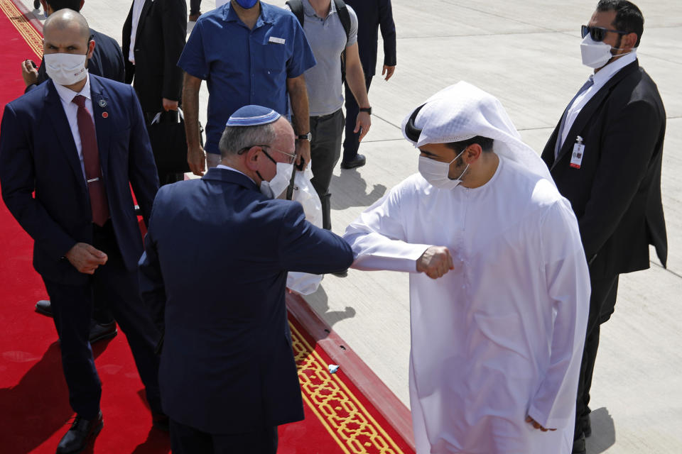 Israeli National Security Advisor Meir Ben-Shabbat, center left, elbow bumps with an Emirati official as he leaves Abu Dhabi, Arab Emirates, Tuesday, Sept. 1, 2020. (Nir Elias/Pool via AP)