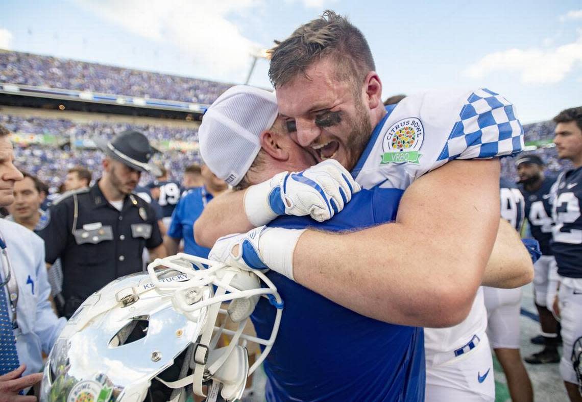 Kentucky tight end C.J. Conrad hugs coach Mark Stoops after they won the Citrus Bowl over Penn State on Tuesday, Jan. 1, 2019 at Camping World Stadium.