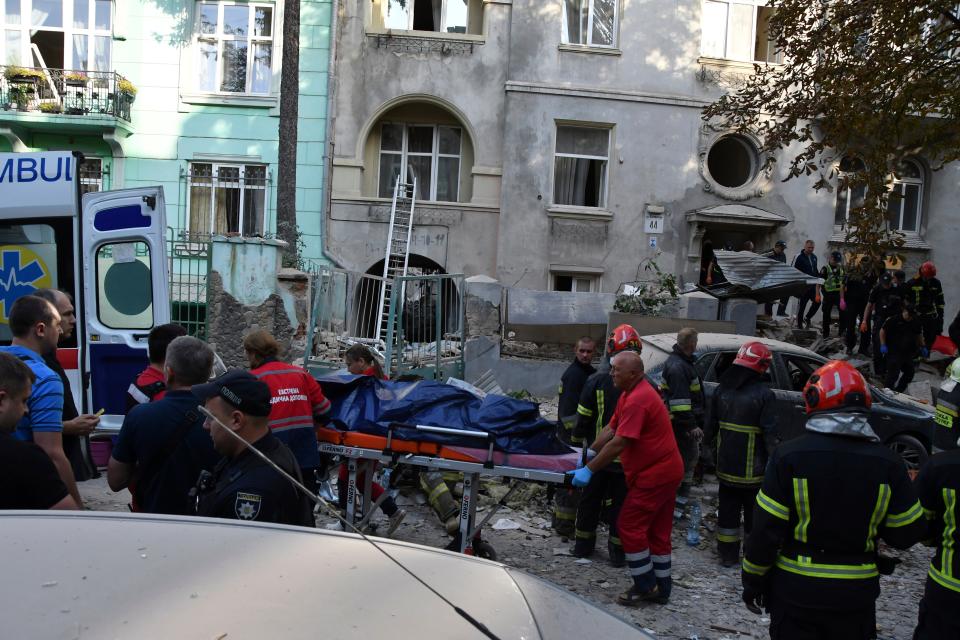 A body is carried out from an apartment building destroyed by Russian missiles (AP)