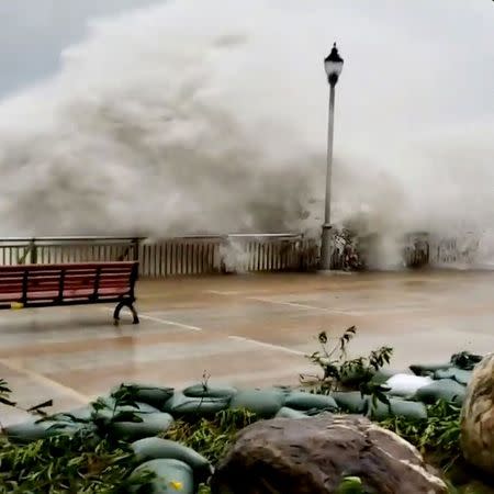 Waves spilling over a sea barriers as Typhoon Mangkhut approaches Hong Kong, China in this still image taken from a social media video on September 16, 2018. INSTAGRAM/@BLOCKCHAINMITV via REUTERS