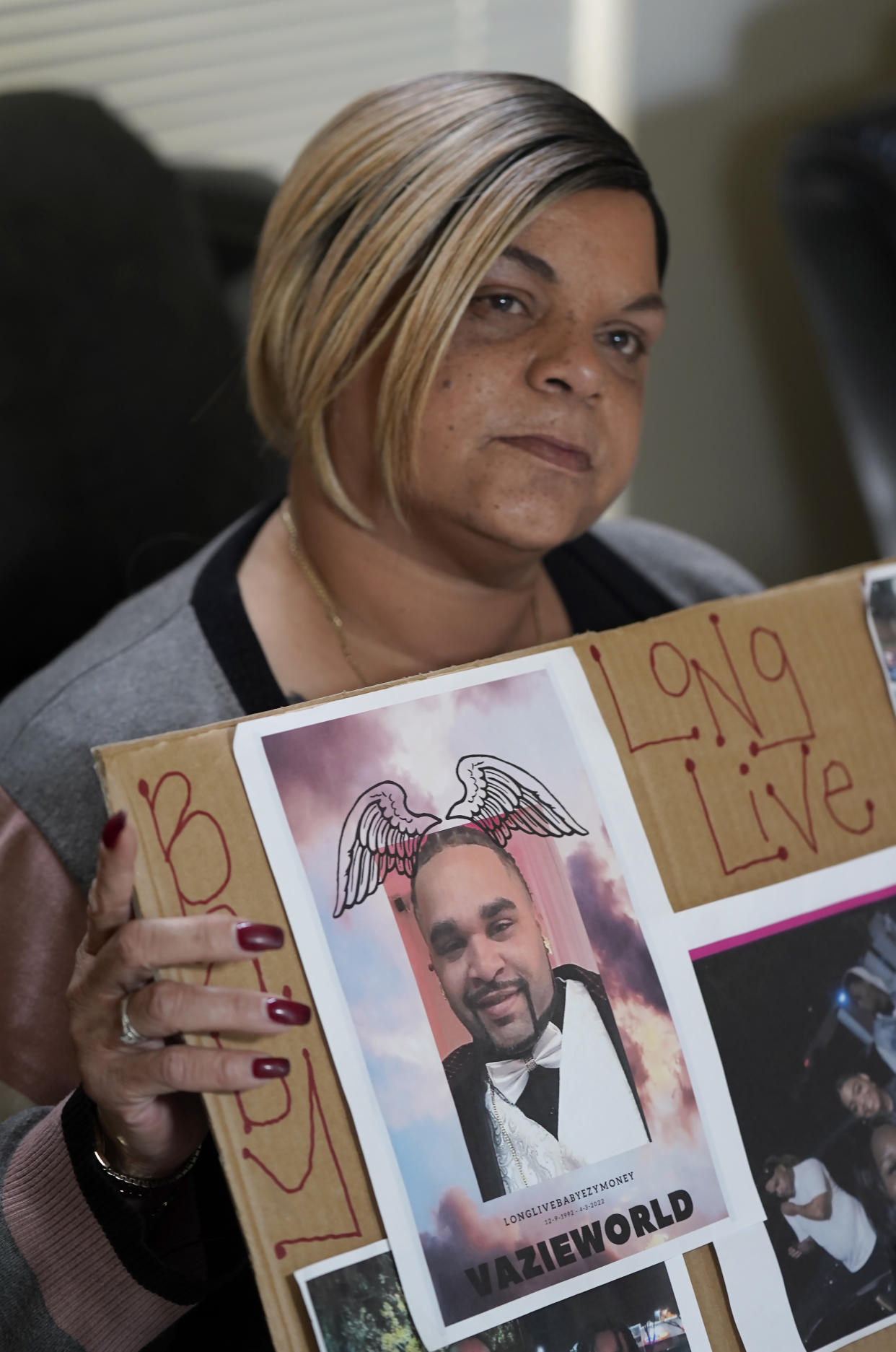 Penelope Scott holds a collection of family photos including one of her son, De'vazia Turner, one of the victims killed in a mass shooting, during an interview with The Associate Press in Elk Grove, Calif., Monday, April 4, 2022. Multiple people were killed and injured in the shooting a day earlier. (AP Photo/Rich Pedroncelli)
