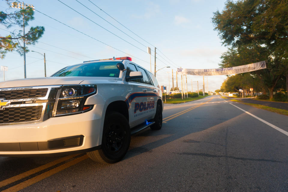 A University of Florida Police vehicle sits in front of a banner listing prohibited items on Hall Road near the entrance to University of Florida in Gainesville on Thursday October, 19 2017.