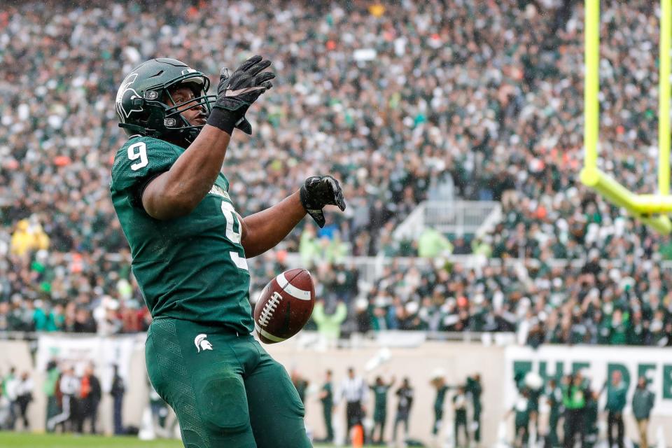 Michigan State running back Kenneth Walker III (9) celebrates a touchdown against Michigan during the second half at Spartan Stadium in East Lansing on Saturday, Oct. 30, 2021.