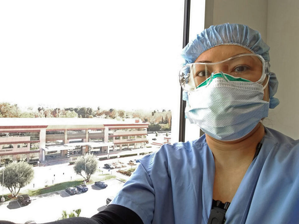 Nurse Nerissa Black takes a selfie wearing protective gear at work on Dec. 13, 2020 at Henry Mayo Newhall Hospital in Valencia, Calif. Black was already having a hard time tending to four COVID-19 patients who need constant heart monitoring. But because of staffing shortages affecting hospitals throughout California, her workload recently increased to six people infected with the coronavirus. Overwhelmed California nurses are now caring for more COVID-19 patients after the state began issuing waivers that allow hospitals to temporarily bypass strict nurse-to-patient ratios. Nurses say the new workload is pushing them to the brink of burnout and affecting patient care. (Nerissa Black via AP)