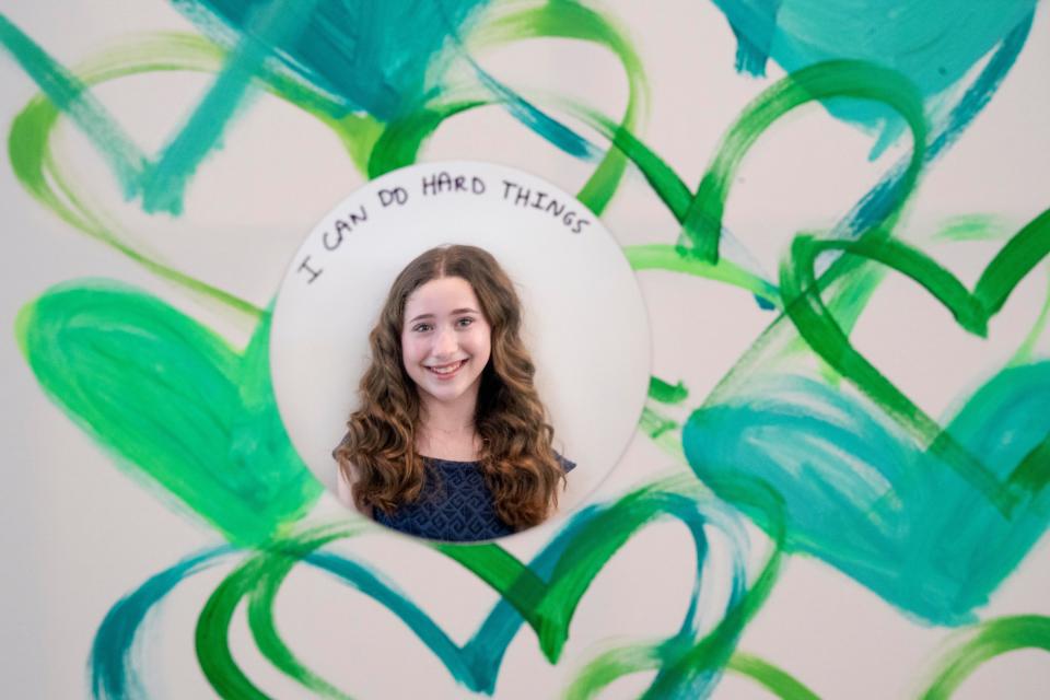 Ayel is reflected in part of her mural, "Voices in Reflections," whichshe created for the Sandy Hook Promise Student Voices Contest to remind yourself to never underestimate the power of your voice.