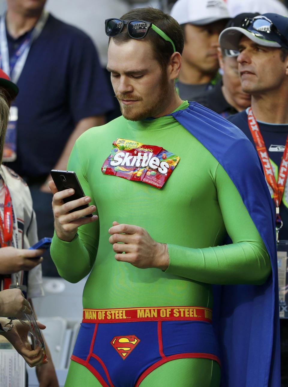 A Seattle Seahawks football fan checks his phone ahead of the start of the NFL Super Bowl XLIX football game against the New England Patriots in Glendale