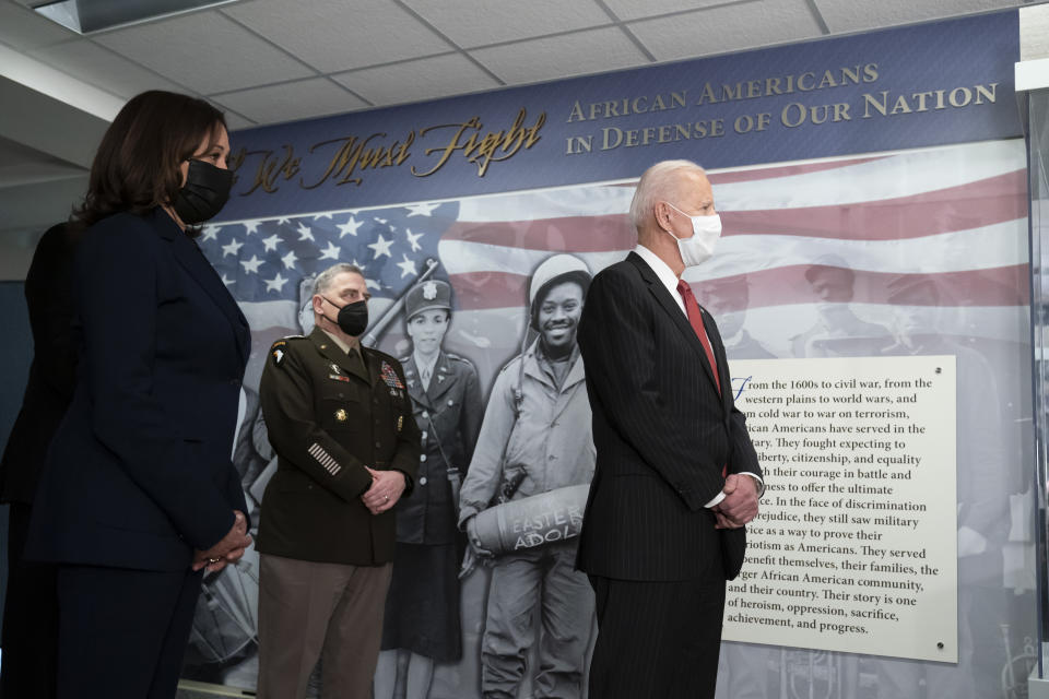 President Joe Biden, accompanied by Vice President Kamala Harris, left, and Joint Chiefs Chairman Gen. Mark Milley, tours the African Americans in Defense of our Nations Corridor at the Pentagon, Wednesday, Feb. 10, 2021, in Washington. (AP Photo/Alex Brandon, Pool)