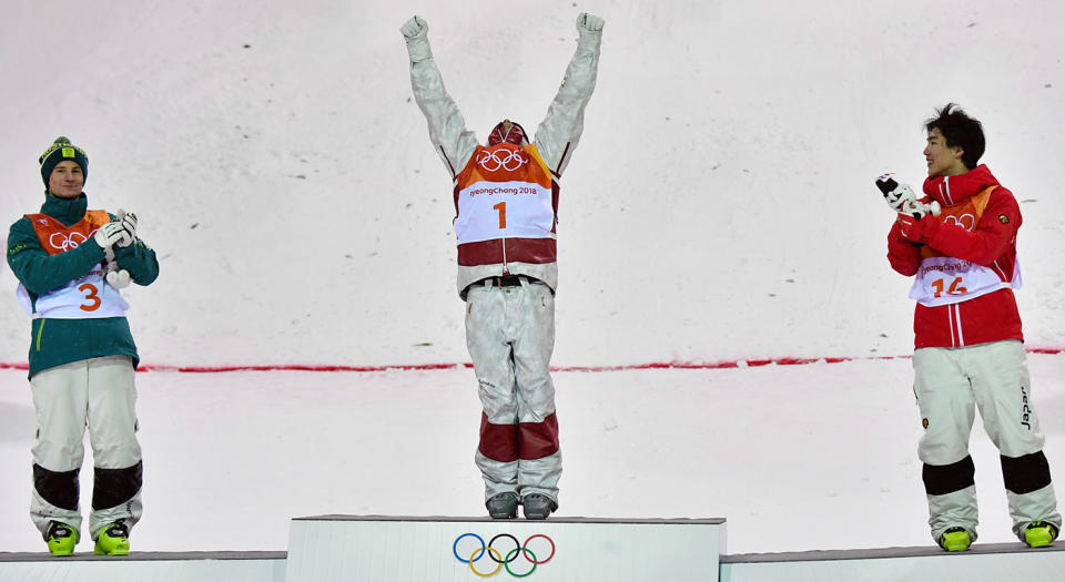 Mikael Kingsbury celebrates on top of the Olympic podium. (Getty)