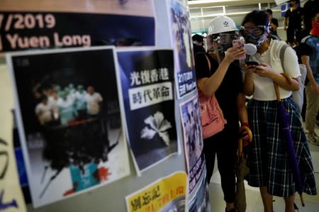 Protest at Yuen Long MTR station, the scene of an attack by suspected triad gang members a month ago, in Hong Kong