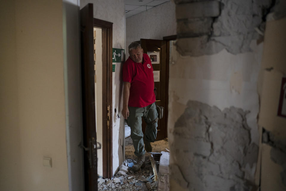 The head of the rapid response unit Taras Logginov walks in the damaged building of the Ukrainian Red Cross Society that was hit last week during a Russian attack in Sloviansk, Ukraine, Monday, Sept. 5, 2022. (AP Photo/Leo Correa)