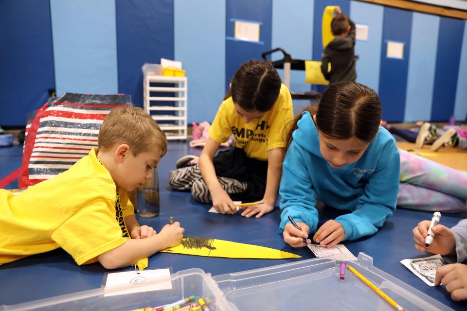A kindergartener and fourth-graders in the house of Empathy create pieces for a larger craft project at Carrie E. Tompkins Elementary School in Croton Nov. 17, 2023. Students in grades K-4 are divided into eight groups or "houses" and once a month they come together to work on different projects together.
