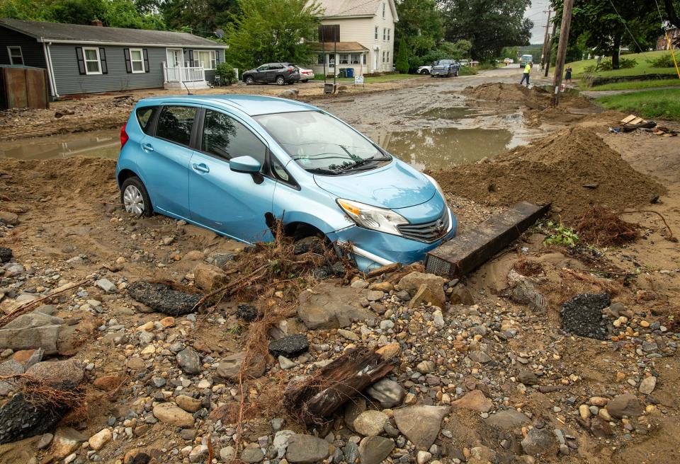 On Hamilton Street Tuesday, a car was surrounded by debris and mud.
