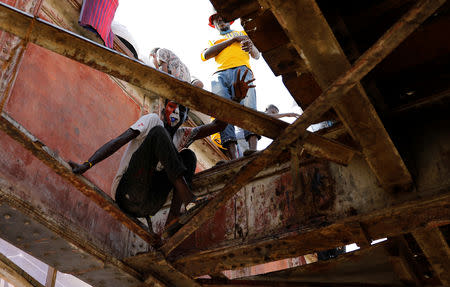 Sudanese protesters stand on a railroad bridge outside the defence ministry compound in Khartoum, Sudan, April 24, 2019. REUTERS/Umit Bektas