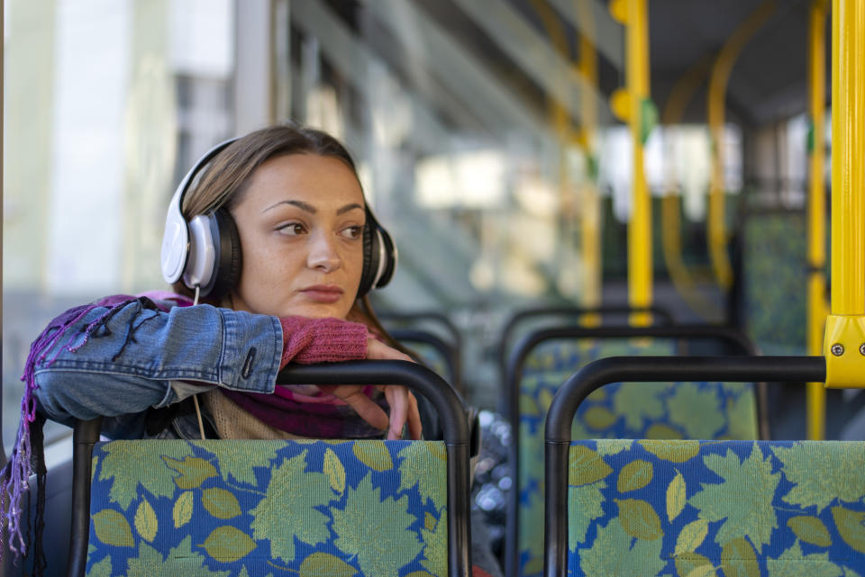 a woman sitting on a public bus alone