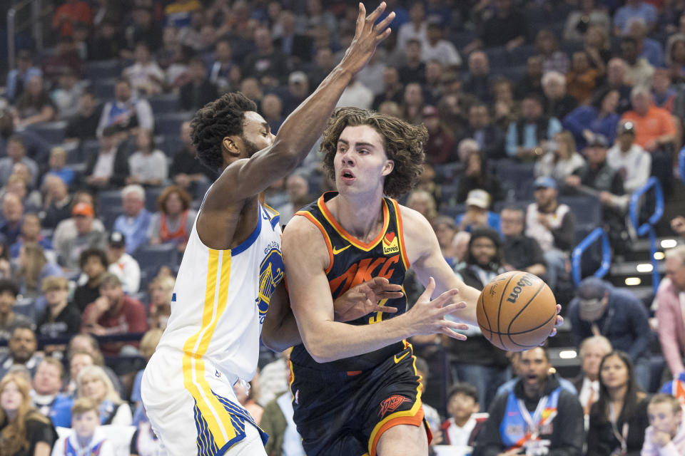 Nov 3, 2023; Oklahoma City, Oklahoma, USA; Golden State Warriors forward Andrew Wiggins (22) defends a drive by Oklahoma City Thunder guard Josh Giddey (3) during the first quarter at Paycom Center. Mandatory Credit: Alonzo Adams-USA TODAY Sports