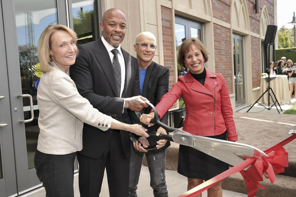 University of Southern California Dean Erica Muhl, from left, Andre "Dr. Dre" Young, Jimmy Iovine and USC President Carol Folt participate in the unveiling of a high-tech building named after Young and Iovine on the University of Southern California campus in Los Angeles on Wednesday, Oct. 2, 2019. The duo donated a combined $70 million in 2013 to create an art, technology and business academy at the college. (Photo by Richard Shotwell/Invision/AP)