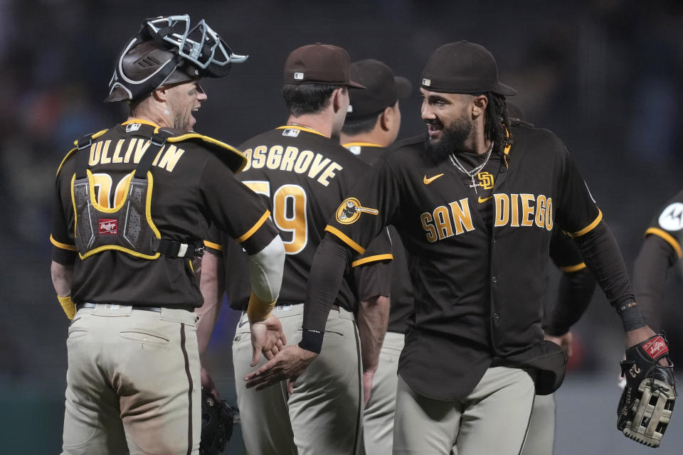 San Diego Padres catcher Brett Sullivan, left, celebrates with right fielder Fernando Tatis Jr. after the Padres defeated the San Francisco Giants in a baseball game in San Francisco, Wednesday, Sept. 27, 2023. The Padres won 5-2 in 10 innings. (AP Photo/Jeff Chiu)