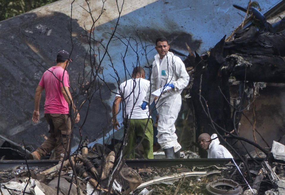 <p>Forensic investigators and Ministry of Interior officers sift through the remains of a Boeing 737 that plummeted into a yuca field with more than 100 passengers on board, in Havana, Cuba, Friday, May 18, 2018. (Photo: Desmond Boylan/AP) </p>