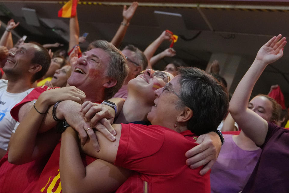 Spanish fans celebrate Spain's victory as they watch the Women's World Cup final soccer match between Spain and England on a large screen, in Madrid, Spain, Sunday, Aug. 20, 2023. (AP Photo/Paul White)