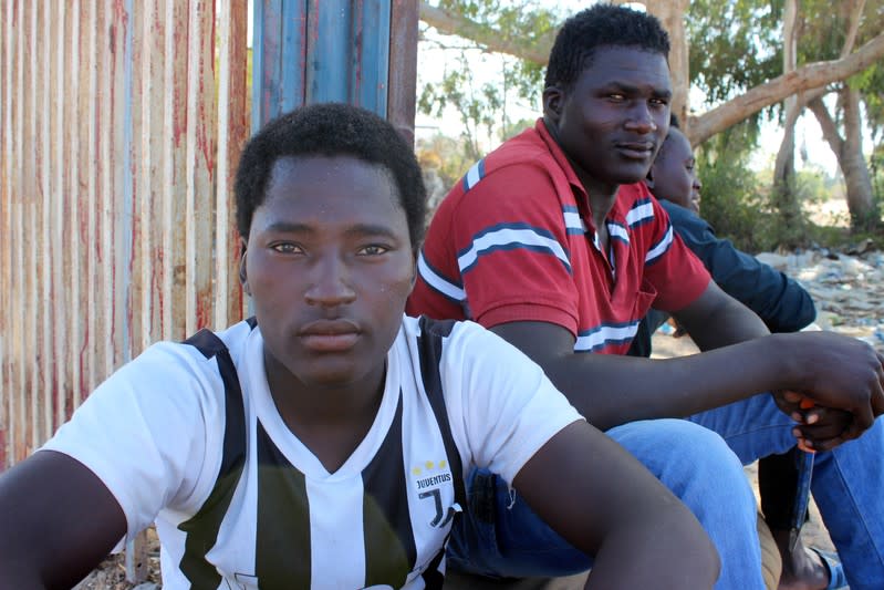 Migrants pose for a photograph on the street, after being rescued by Libyan coast guard, in Misrata