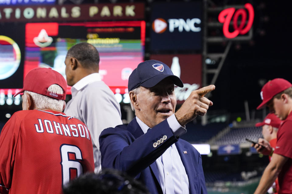 President Joe Biden points to a fan from the Republican dugout during the Congressional baseball game at Nationals Park Wednesday, Sept. 29, 2021, in Washington. The annual baseball game between Congressional Republicans and Democrats raises money for charity. (AP Photo/Alex Brandon)