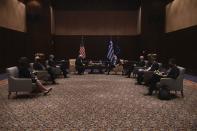 U.S. Secretary of State Mike Pompeo, background left, Greek Foreign Minister Nikos Dendias, background right, and their delegations join a meeting in the northern city of Thessaloniki, Greece, Monday, Sept. 28, 2020. Pompeo and Dendias, will sign a bilateral science and technology agreement, as well as host energy sector business leaders for a discussion to highlight energy diversification and infrastructure projects in Greece. (AP Photo/Giannis Papanikos, Pool)