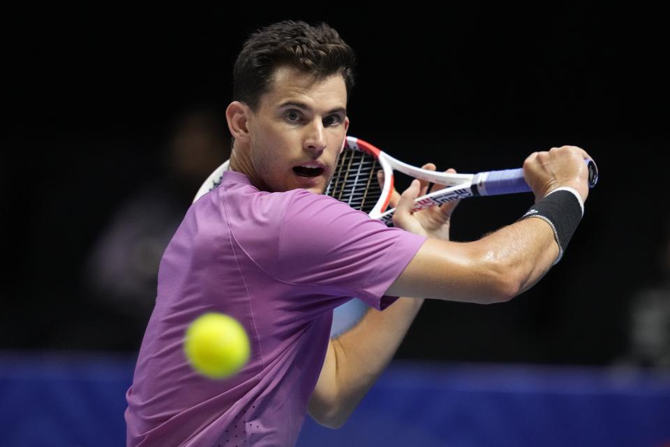 Dominic Thiem of Hawks, returns the ball to Felix Auger-Aliassime of Kites, during a match of the World Tennis League at Coca-Cola Arena, in Dubai, United Arab Emirates, Thursday, Dec. 22, 2022. (AP Photo/Kamran Jebreili)