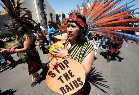 An Aztec takes part in a march with her newborn baby from the intersection of Florence and Normandie Avenue, the flashpoint where the riots started 25 years ago, to a nearby park for a rally to remember and honor the victims of the 1992 Los Angeles riots in Los Angeles, California, U.S., April 29, 2017. REUTERS/Kevork Djansezian