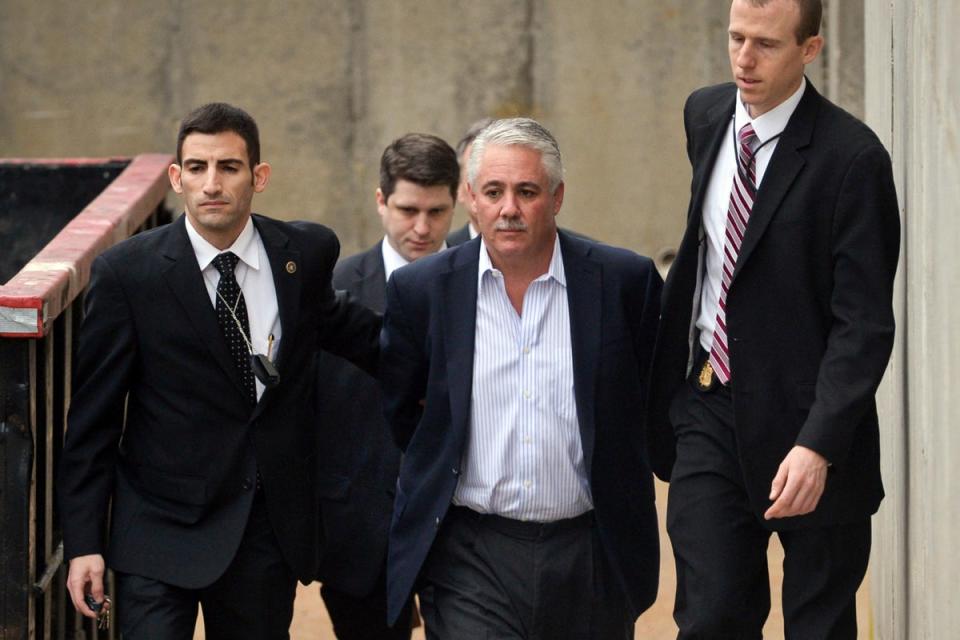 Former Suffolk County Police Chief James Burke, second from right, is escorted to a vehicle by FBI personnel  after his arrest in 2015 (Steve Pfost)