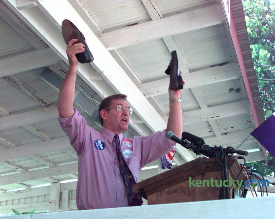 U.S. Rep. Scotty Baesler, D-Lexington, held a pair of shoes that belonged to retiring U.S. Sen. Wendell Ford that he said he intended to fill if he won Ford’s seat. Baesler, speaking at the Fancy Farm picnic in western Kentucky on Aug. 1, 1998, was running against fellow U.S. Rep. Jim Bunning, R-Fort Henry. Bunning narrowly defeated Baesler in the general election.