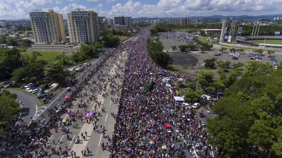 Demonstrators march on Las Americas highway demanding the resignation of governor Ricardo Rossello, in San Juan, Puerto Rico, Monday, July 22, 2019. Protesters are demanding Rossello step down for his involvement in a private chat in which he used profanities to describe an ex-New York City councilwoman and a federal control board overseeing the island's finance. (AP Photo/Gianfranco Gaglione)