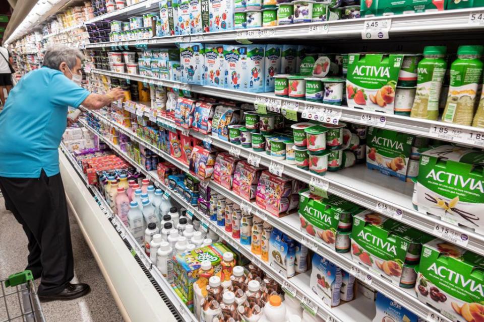 elderly man in yogurt aisle, shopping at designated senior time during pandemic