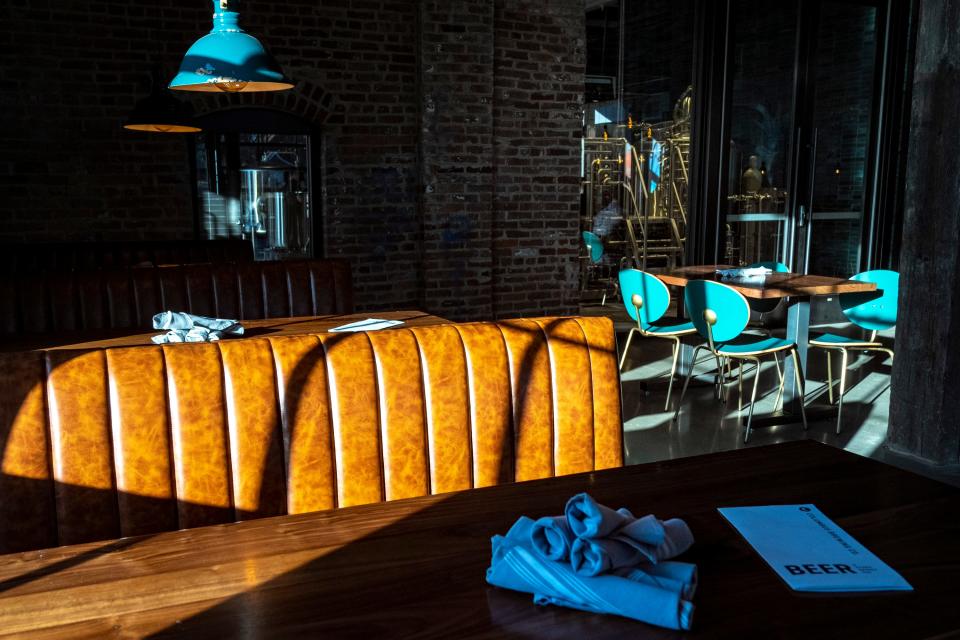 Feb 21, 2023; Columbus, Ohio, United States;  Sunlight drifts through a large vaulted window onto one of two dining areas at Columbus Brewing Company’s newly opened beer hall in Franklin Park. Mandatory Credit: Joseph Scheller-The Columbus Dispatch
