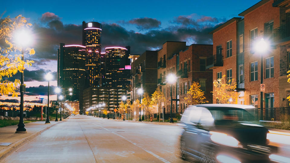 Streets of Detroit with Renaissance center at night.