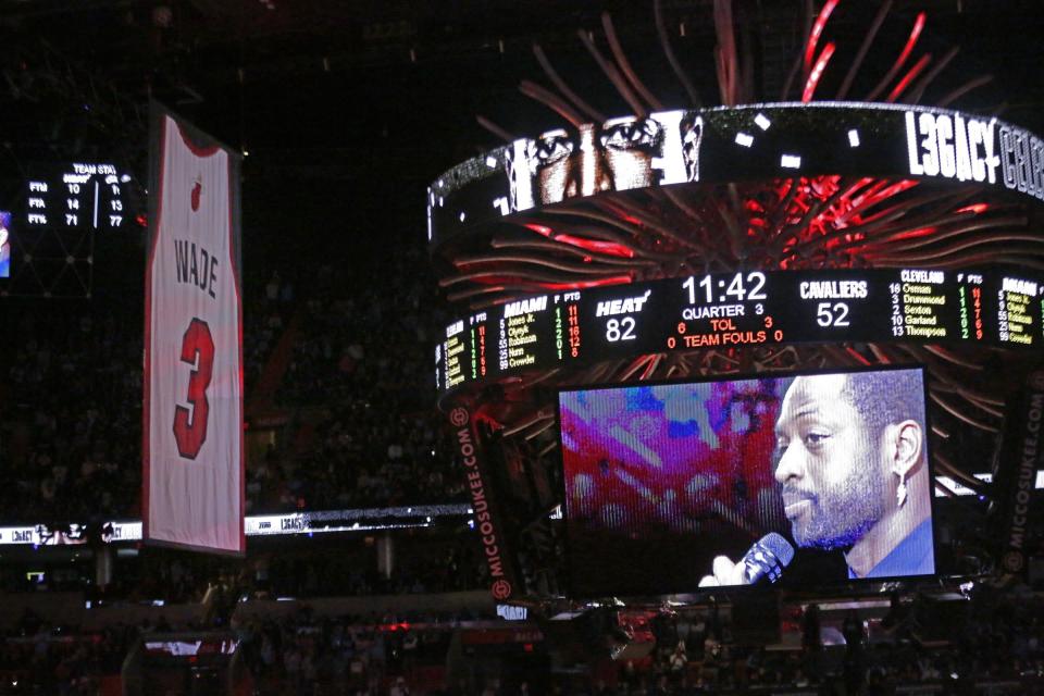 Former Miami Heat guard Dwyane Wade is seen on a video screen as his jersey number is raised at halftime of an NBA basketball game between the Heat and the Cleveland Cavaliers on Saturday, Feb. 22, 2020, in Miami. (David Santiago/Miami Herald via AP)