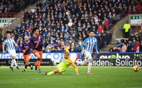 Leroy Sane of Manchester City scores his sides third goal during the Premier League match between Huddersfield Town and Manchester Cit - Credit: Getty Images