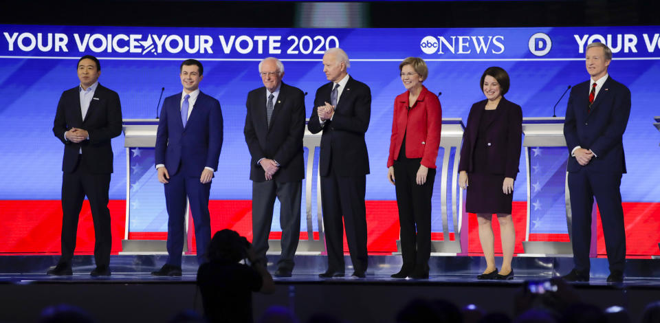 From left, Democratic presidential candidates entrepreneur Andrew Yang, former South Bend Mayor Pete Buttigieg, Sen. Bernie Sanders, I-Vt., former Vice President Joe Biden, Sen. Elizabeth Warren, D-Mass., Sen. Amy Klobuchar, D-Minn., and businessman Tom Steyer stand on stage Friday, Feb. 7, 2020, stand on stage before the start of a Democratic presidential primary debate hosted by ABC News, Apple News, and WMUR-TV at Saint Anselm College in Manchester, N.H. (AP Photo/Charles Krupa)
