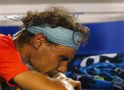 Rafael Nadal of Spain reacts as he receives treatment during his men's singles final match against Stanislas Wawrinka of Switzerland at the Australian Open 2014 tennis tournament in Melbourne January 26, 2014. REUTERS/Petar Kujundzic